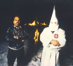 Dressed in white: Davis and a Klans member who wishes to remain anonymous stand in front of a burning cross at a KKK rally. Through his interactions with Klans members, Daryl has attended many of these rallies accross the county.