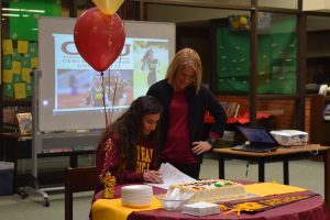 Coach and mom Maggie Rettelle supports her daughter, senior Maija Rettelle as she signs to run track at Central Michigan University.